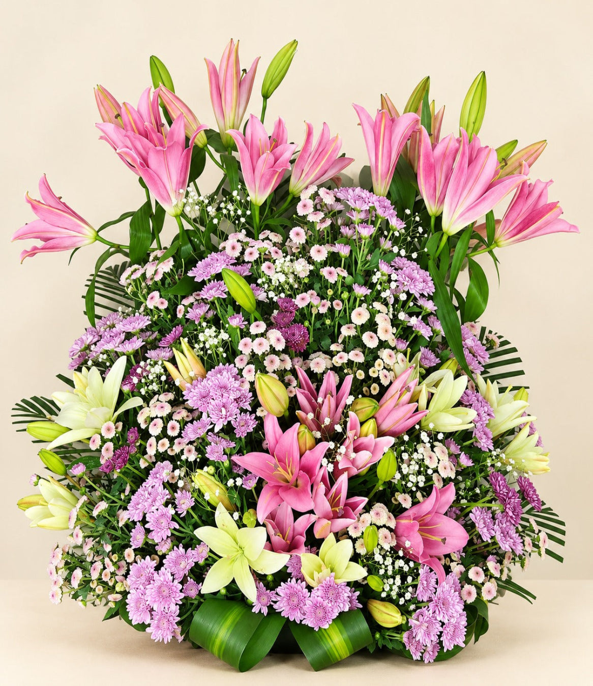 Grand floral arrangement with pink lilies, white lilies, purple chrysanthemums and lush greenery by Whitefields