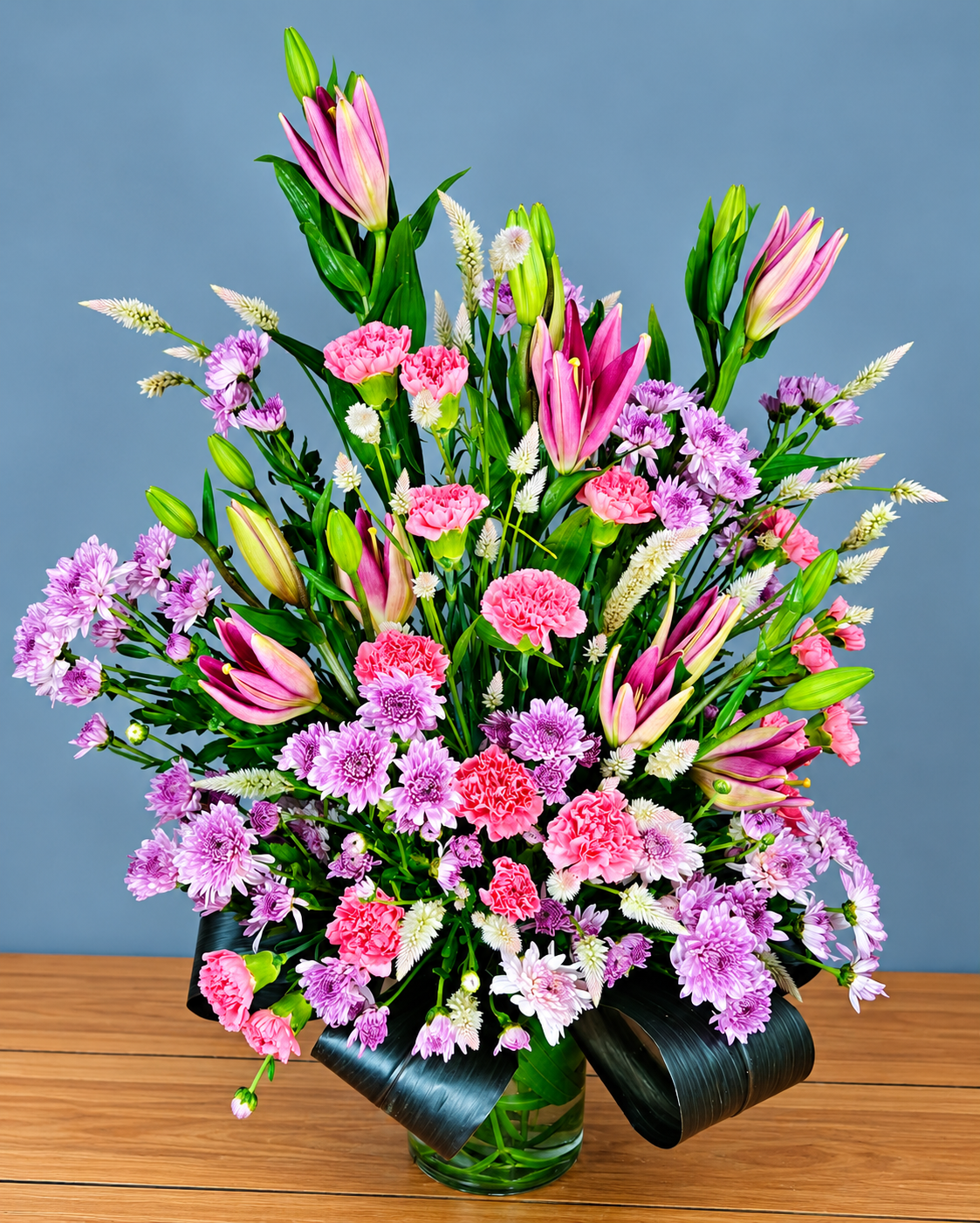 Pink Lily Charm bouquet with pink lilies, carnations and lavender flowers for delivery in Gurgaon and Delhi NCR