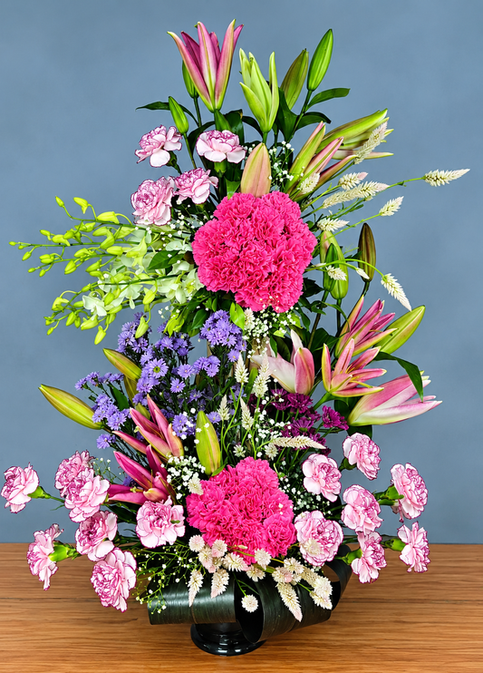Pink carnation and lily flower arrangement with lavender blooms baby's breath and green foliage by WhiteFields