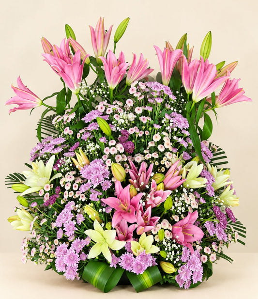 Grand floral arrangement with pink lilies, white lilies, purple chrysanthemums and lush greenery by Whitefields