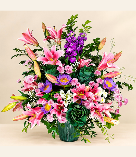 Pink lily floral arrangement with purple seasonal flowers, pink chrysanthemums and decorative greenery by Whitefields